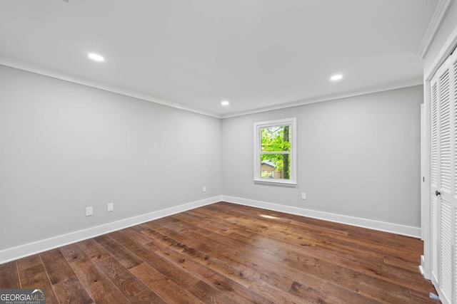 unfurnished bedroom featuring crown molding, baseboards, and dark wood-type flooring