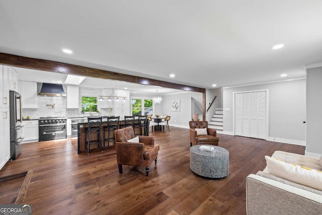 living room featuring stairs, dark wood-style flooring, and recessed lighting