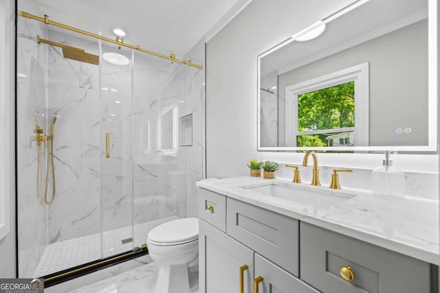 full bathroom featuring a marble finish shower, vanity, toilet, and marble finish floor