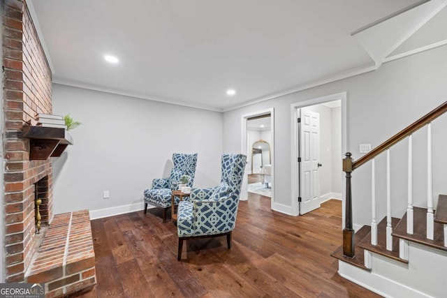 living area featuring stairs, recessed lighting, wood finished floors, and a fireplace