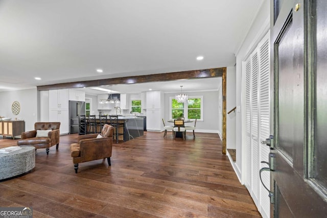 living area featuring ornamental molding, dark wood-type flooring, recessed lighting, and a chandelier