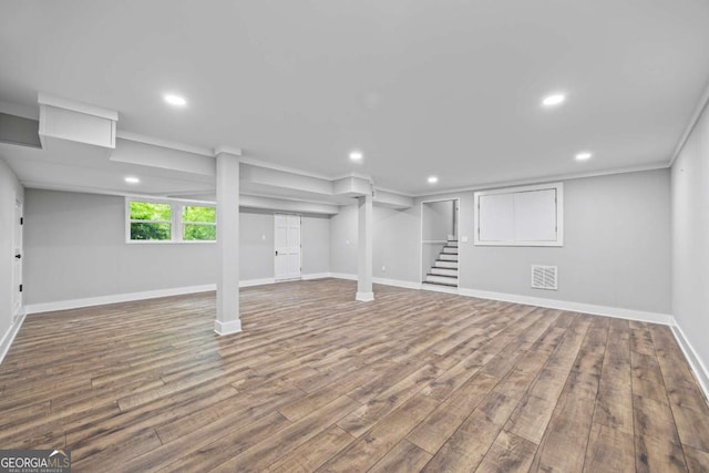 basement with stairs, recessed lighting, baseboards, and wood finished floors