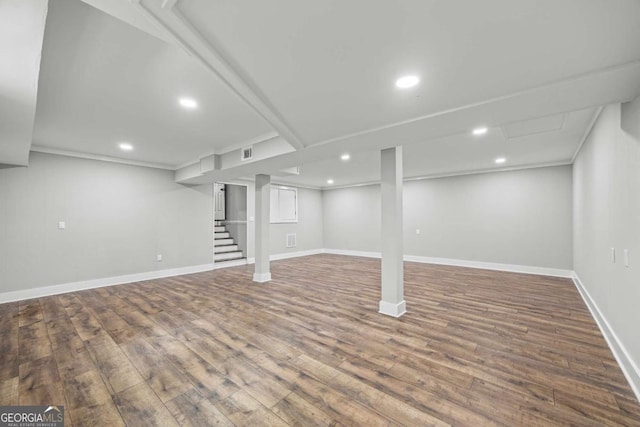 finished below grade area with baseboards, recessed lighting, wood finished floors, and visible vents