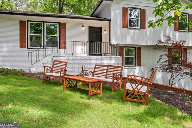 exterior space featuring brick siding and a lawn