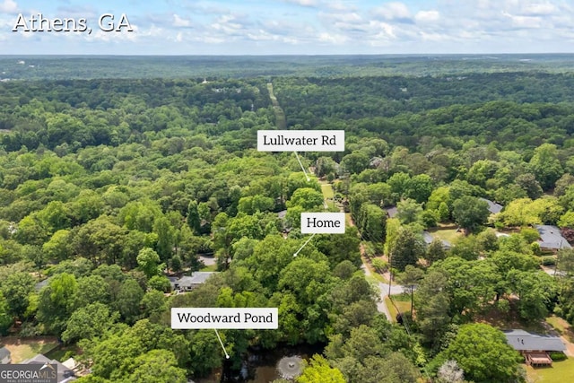 birds eye view of property with a wooded view