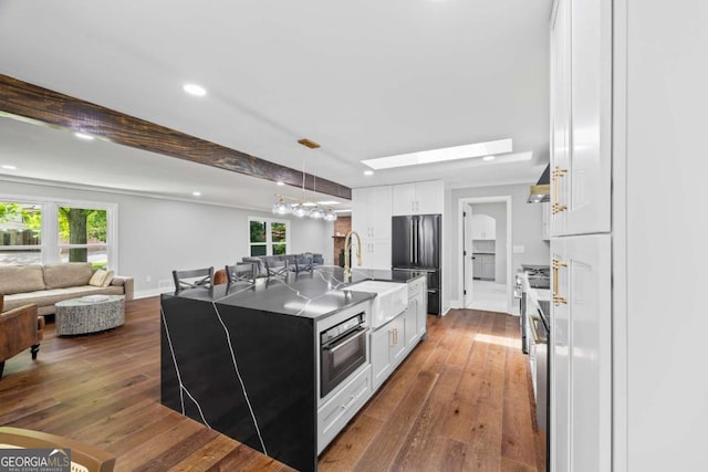 125 Terrell Dr, Athens, GA 30606 - kitchen featuring freestanding refrigerator, open floor plan, white cabinetry, dark wood-style floors, and recessed lighting