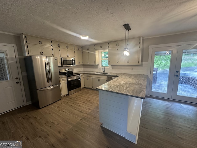 490 Piedmont Hwy, Centre, AL 35960 - kitchen featuring stainless steel appliances, white cabinetry, a peninsula, ornamental molding, and dark wood-type flooring