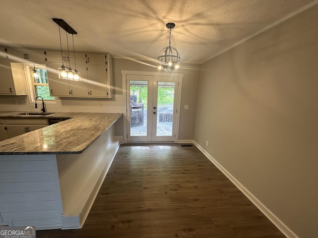 490 Piedmont Hwy, Centre, AL 35960 - kitchen with a textured ceiling, white cabinetry, dark wood finished floors, a chandelier, and healthy amount of natural light