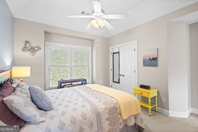 bedroom featuring a ceiling fan, visible vents, baseboards, a closet, and light carpet