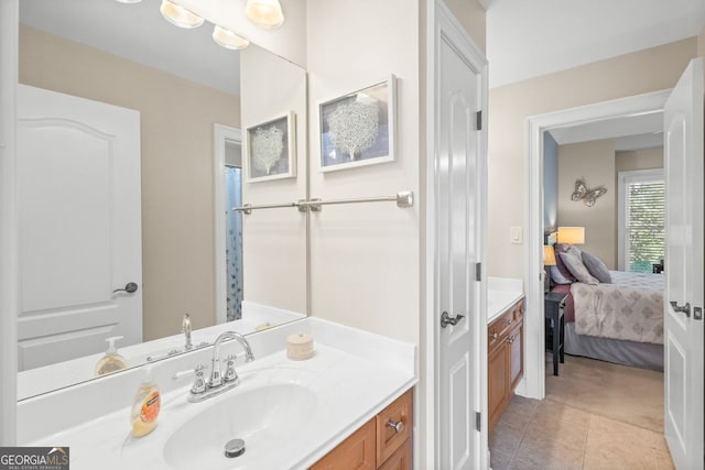 ensuite bathroom featuring vanity, tile patterned flooring, and connected bathroom