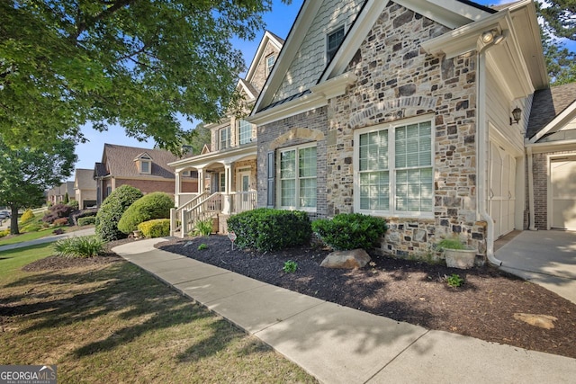view of front facade featuring covered porch and stone siding