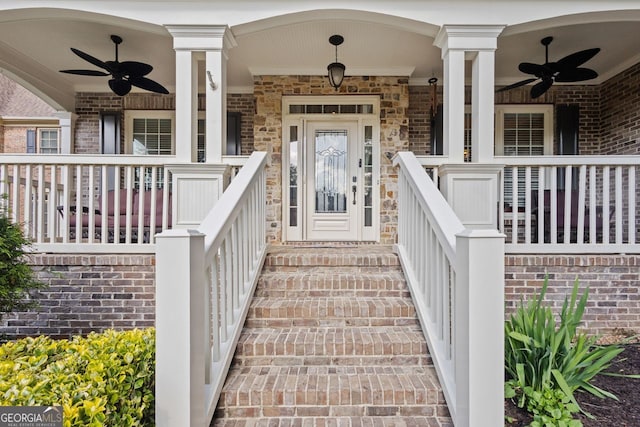 view of exterior entry with a porch and ceiling fan