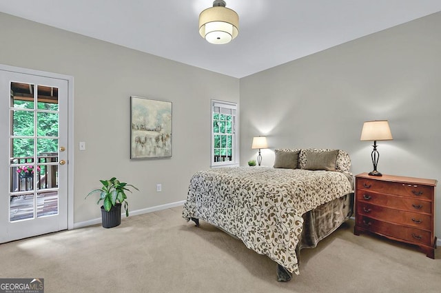 carpeted bedroom with access to outside and baseboards