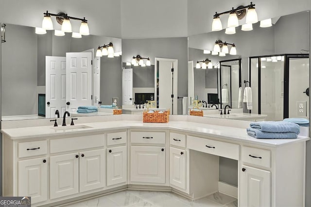 full bath with double vanity, a sink, marble finish floor, and a shower stall