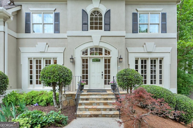 doorway to property with stucco siding