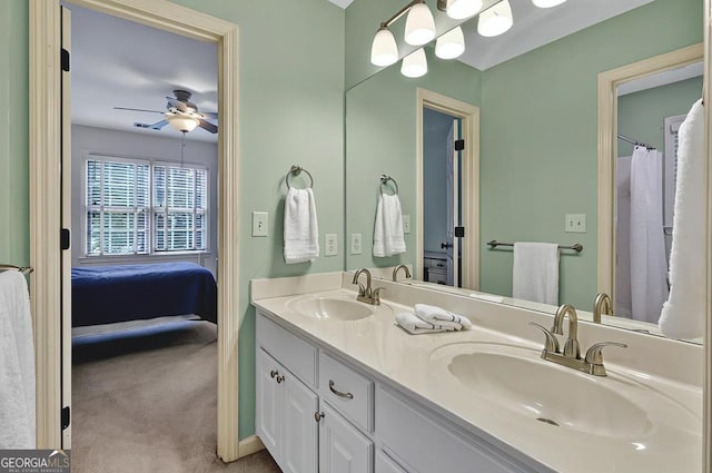 ensuite bathroom with a sink, a ceiling fan, double vanity, and connected bathroom