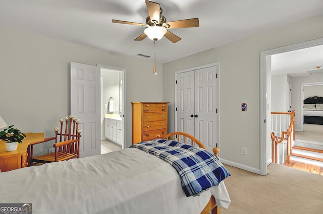 bedroom featuring ceiling fan, visible vents, light colored carpet, baseboards, and a closet