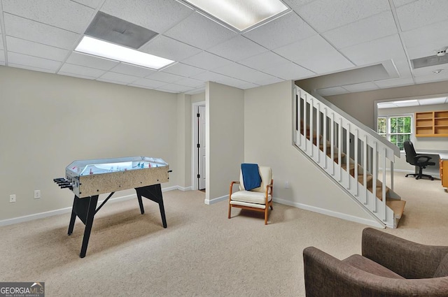 game room featuring baseboards, carpet flooring, and a paneled ceiling