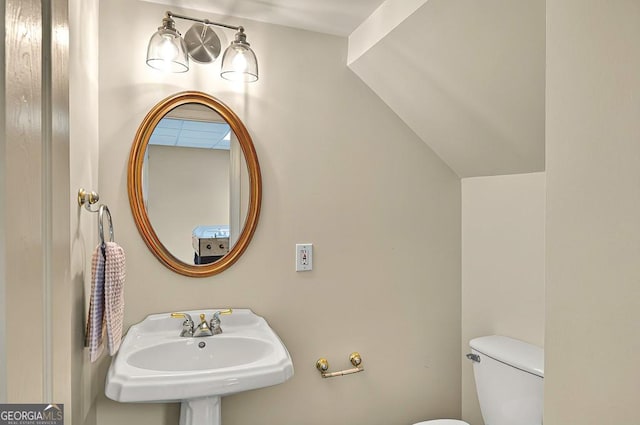 half bath featuring a sink and toilet