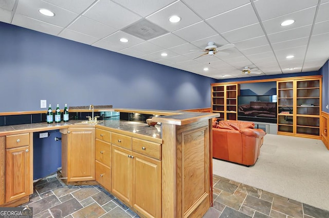 kitchen featuring ceiling fan, recessed lighting, a sink, stone finish flooring, and dishwasher
