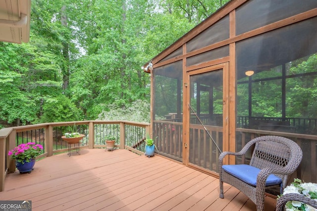 wooden deck with a sunroom