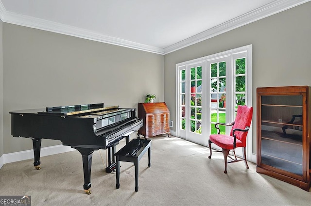 sitting room featuring baseboards, ornamental molding, and carpet
