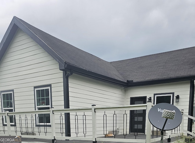 exterior space featuring a shingled roof