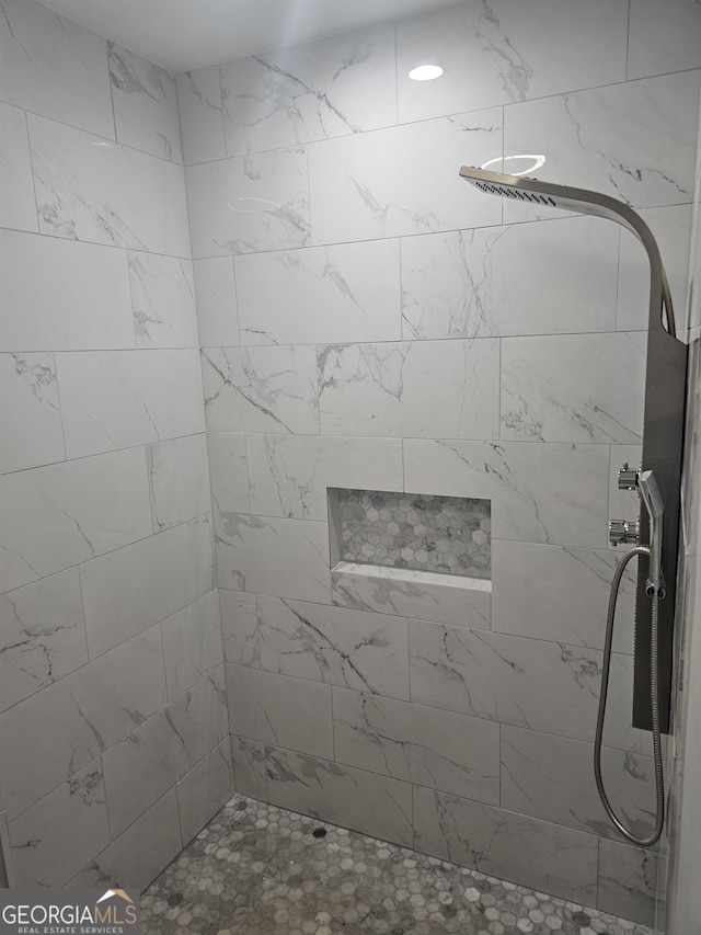 full bath featuring a tile shower