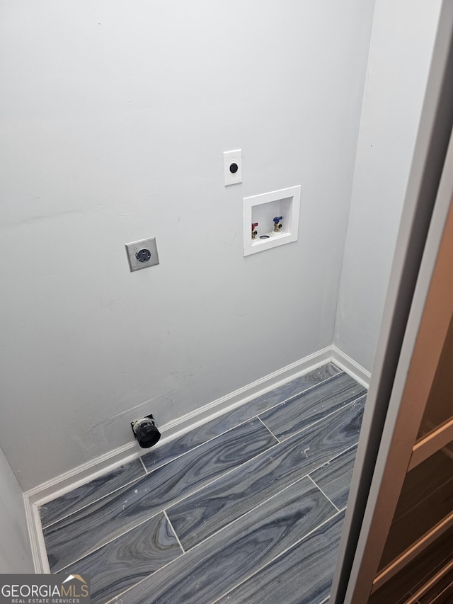washroom featuring washer hookup, hookup for an electric dryer, baseboards, and laundry area