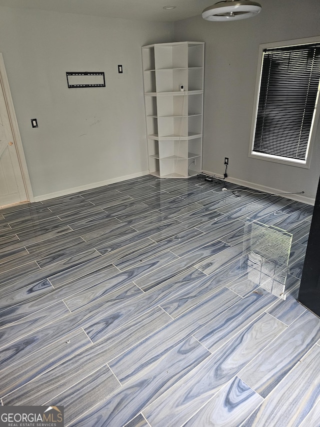 unfurnished room featuring baseboards