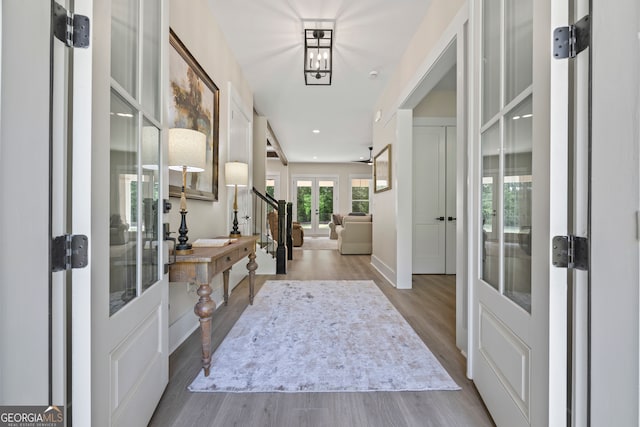 entryway featuring french doors, recessed lighting, baseboards, and wood finished floors