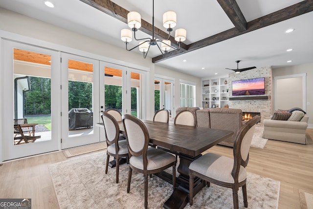dining area with recessed lighting, french doors, a healthy amount of sunlight, and a fireplace