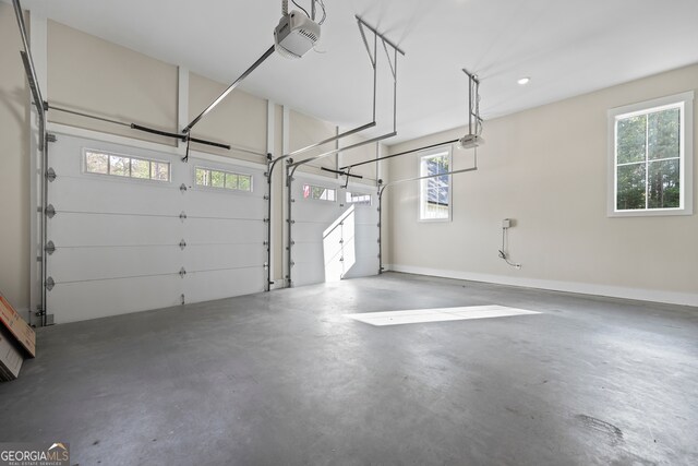 garage with baseboards and a garage door opener