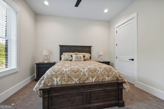 carpeted bedroom with baseboards, recessed lighting, ceiling fan, and multiple windows