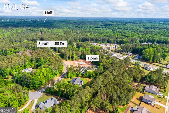 drone / aerial view with a residential view and a wooded view