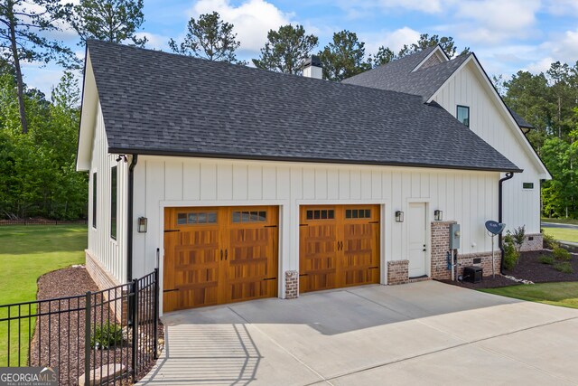 garage with fence and driveway