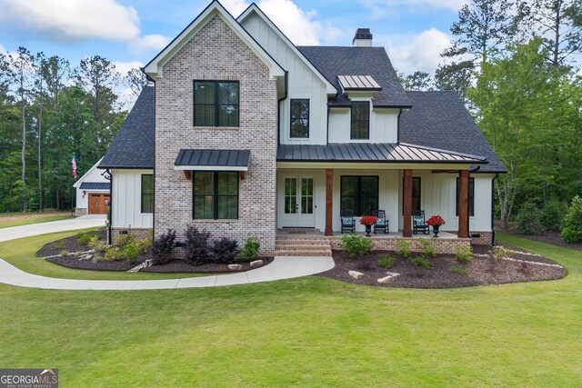 view of front of property with board and batten siding, a standing seam roof, a shingled roof, and a porch