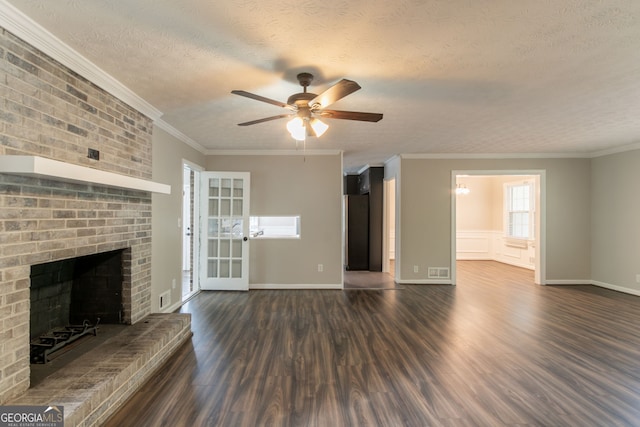 2814 Brackenwood Dr, Snellville, GA 30039 - unfurnished living room featuring dark wood-type flooring, ceiling fan, a fireplace, a textured ceiling, and crown molding