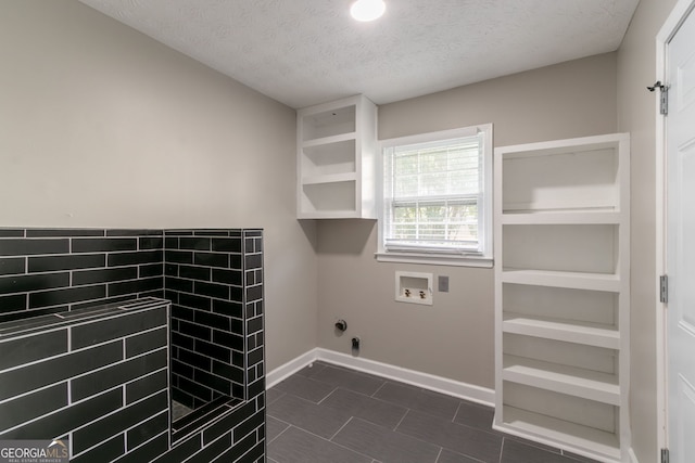 2814 Brackenwood Dr, Snellville, GA 30039 - washroom featuring a textured ceiling, washer hookup, and dark tile patterned floors
