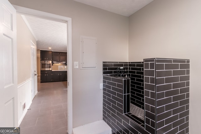 2814 Brackenwood Dr, Snellville, GA 30039 - bathroom with a textured ceiling, electric panel, tile patterned flooring, and crown molding