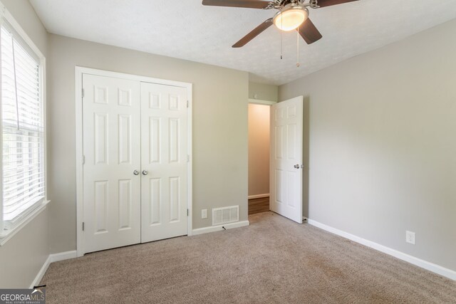 2814 Brackenwood Dr, Snellville, GA 30039 - unfurnished bedroom featuring multiple windows, carpet floors, and a closet