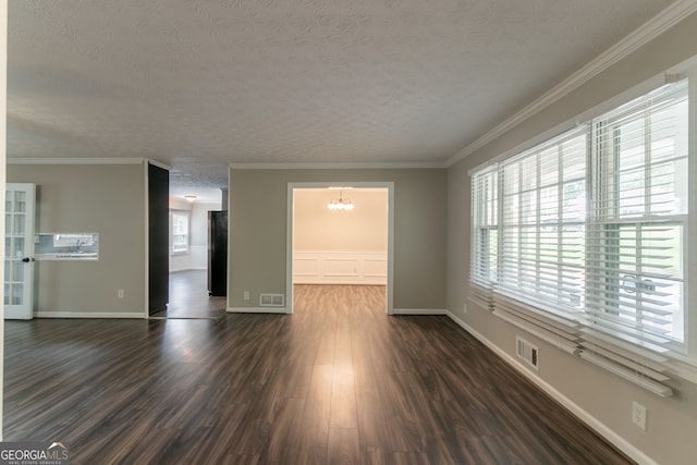 2814 Brackenwood Dr, Snellville, GA 30039 - unfurnished room featuring a chandelier, a textured ceiling, dark wood-style flooring, and crown molding