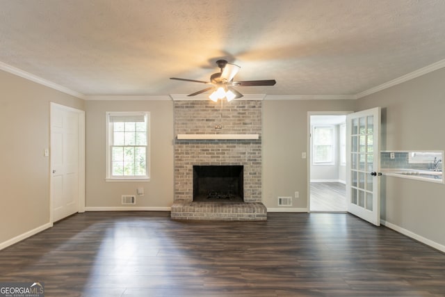 2814 Brackenwood Dr, Snellville, GA 30039 - unfurnished living room featuring a ceiling fan, dark wood-style flooring, a textured ceiling, a fireplace, and crown molding