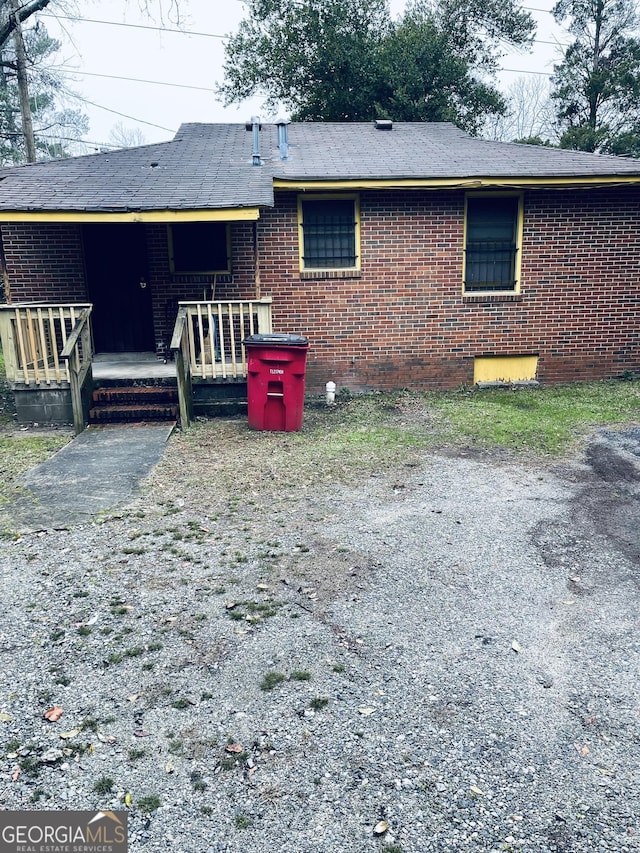rear view of house featuring brick siding