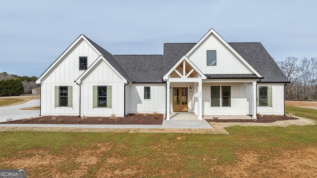 modern inspired farmhouse with a shingled roof, board and batten siding, french doors, and a front yard