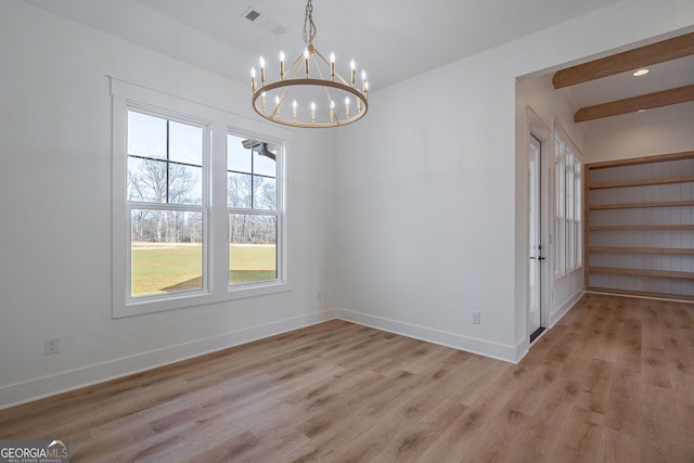 unfurnished dining area featuring baseboards, visible vents, light wood-type flooring, and a chandelier