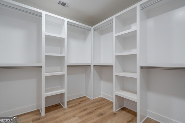 walk in closet featuring wood finished floors and visible vents