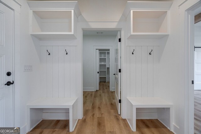 mudroom with light wood finished floors