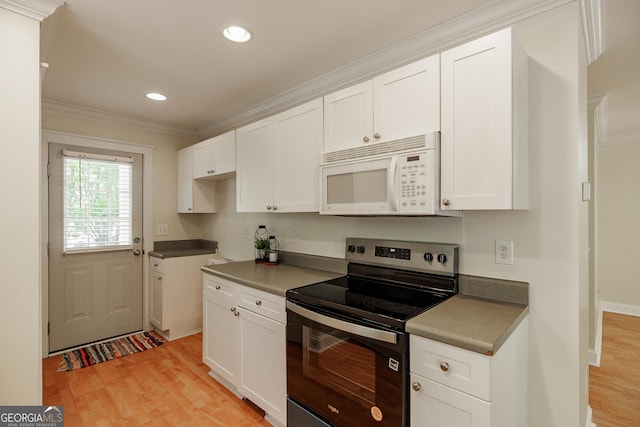 kitchen featuring ornamental molding, stainless steel electric range, white microwave, and light wood-style flooring