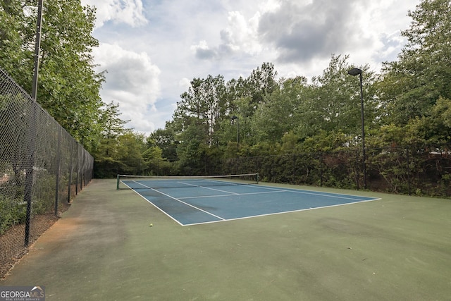 view of sport court with fence